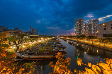 Springtime in Saigon, boat on canal, transport spring flower for Tet to Ben Binh Dong open air market, Vietnamese happy with Lunar New Year, Vietnam
