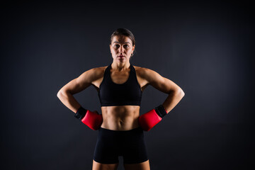 Fototapeta na wymiar Woman Boxer In Gloves Training On black, red, yellow Background
