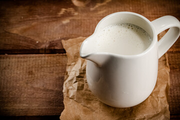 A jug of fresh milk on the table. 