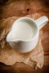 A jug of fresh milk on the table. 