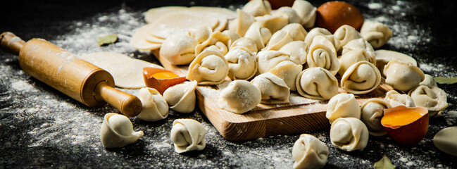 Making homemade dumplings. On a black background.