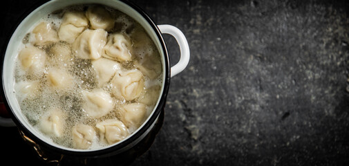 Dumplings are boiled in a saucepan in boiling water. 