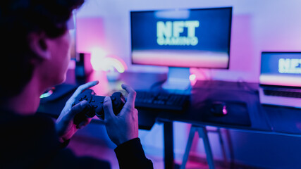 Young gamer having fun playing on decentralized NFT gaming blockchain platform with virtual reality glasses at home - Gaming entertainment and technology concept © Alessandro Biascioli