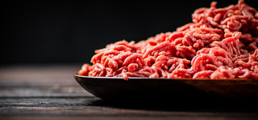 Fresh minced meat on the table on a plate. 