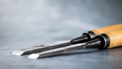 Chisel on wood on the table. 