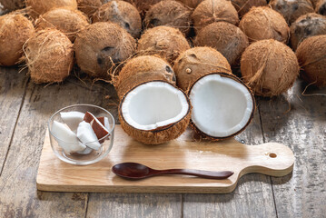 Hand carry piece of coconut for made virgin oil. Virgin coconut oil liquid clear pure by cold pressed with HDL by Raw coconut milk regular saturated fat good cholesterol in Virgin coconut oil liquid 