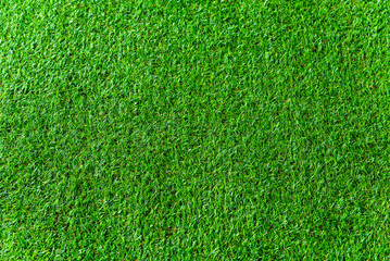 Fototapeta premium Green artificial grass natural background texture soccer field.
