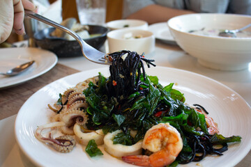 Spaghetti with Spicy Mixed Seafood and basil.Thai fusion food.