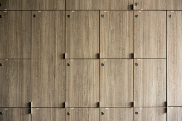 Wooden lockers with key in locker room at school sport club office.