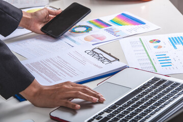 legal adviser reading examine draft contract in notebook and paper
