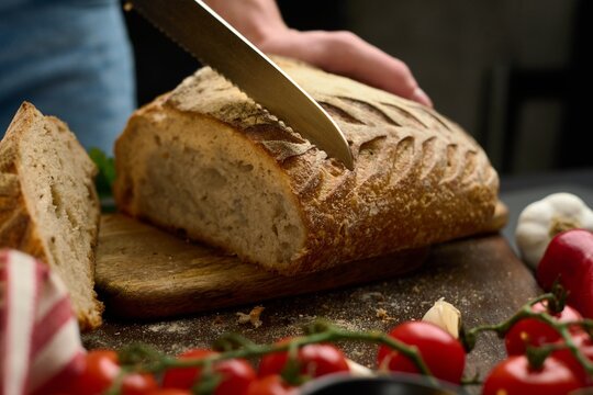 Slicing bread on table close up video