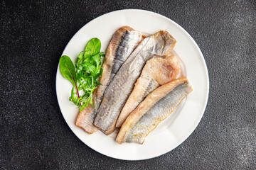 herring salted fish fillet fresh seafood healthy meal food snack on the table copy space food background rustic top view