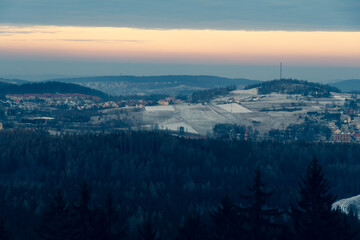 Panoramic view from the top of Dzikowiec Mountain, in Boguszow-Gorce near Walbrzych in Poland. Branches in foreground, selective focus. Popular viewing tower.