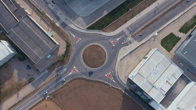 Roundabout traffic of cars and trucks on the circle ring road aerial top view