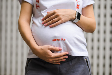 Image of a pregnant woman touching her belly with her hands
