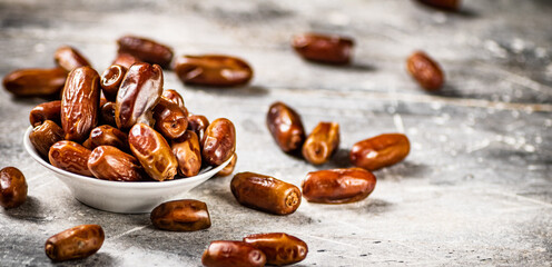 Full bowl with dates on the table. 