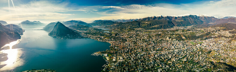 Fototapeta premium Lugano, Switzerland. Amazing view of the Swiss city, surrounded by lake and mountains.