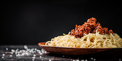 Freshly cooked spaghetti bolognese. On a black background.