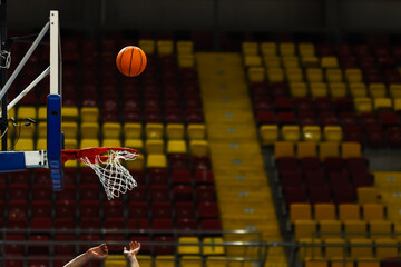 Basket ball and a basketball glass board with rim.