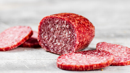 Pieces of delicious salami sausage on the table. 