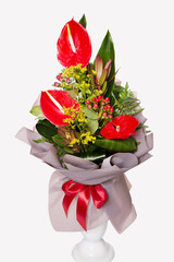 Gift bouquet of red callas and other flowers.