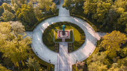 A statue of Taras Shevchenko in the center of the city park. Taras Shevchenko Park opposite the university - obrazy, fototapety, plakaty