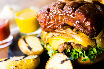 Premium Authentic American Burger with a tender pork rib on top.