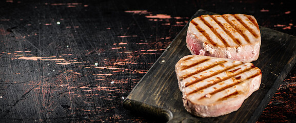 Delicious grilled tuna steak on a cutting board. 