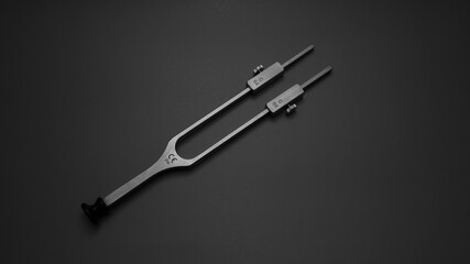 tuning fork C 128 on a grey background with gradation