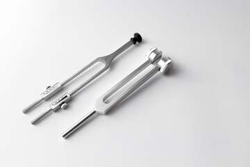 tuning fork C 128 on a white background with gradation