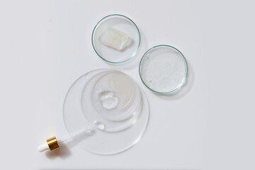 Glass petri dish with transparent pure serum for skin care
