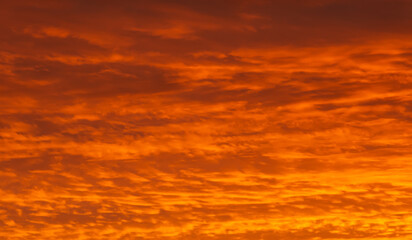 Fototapeta premium A fragment of a colorful sunset twilight sky. Bright orange and dark red