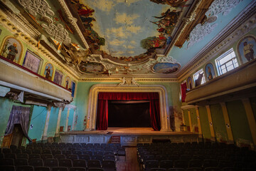 Old abandoned ruined stage theater with paintings
