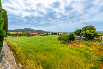 Fototapeta na wymiar View of a Spanish villa and the Catalonian hills and countryside from the medieval village of Pals, Spain, in the Girona province of Northern Spain along the Costa Brava Coast. 