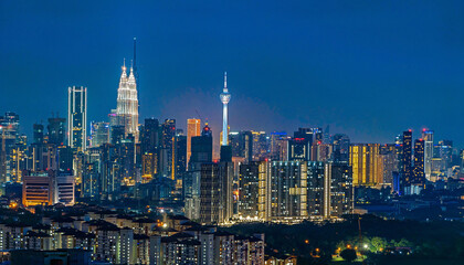 Cityscape of Kuala Lumpur, Malaysia at night with blue sky