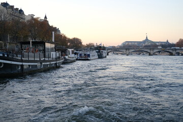 Fototapeta premium A view of the Seine river during dusk. December 2022, Paris, France.