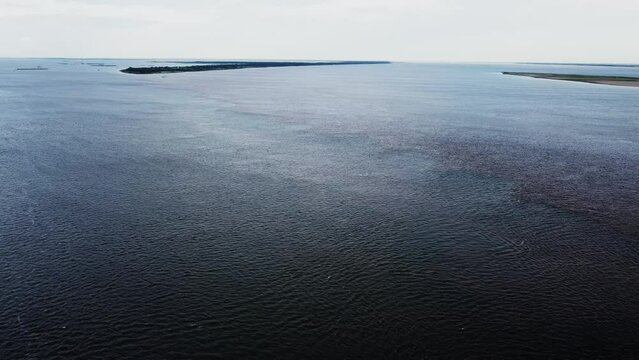 looking up river along the Confluence of the Green Blue Rio Tapajos and the Brown Rio Amazon rivers Aerial Video.