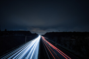 Fototapeta na wymiar Langzeitbelichtung - Autobahn - Strasse - Traffic - Travel - Background - Line - Ecology - Highway - Night Traffic - Light Trails - High quality photo 
