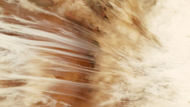 Super Slow Motion Abstract Shot of Pouring Cream into Coffee at 1000fps.
