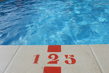 Swimming pool edge with depth mark 125