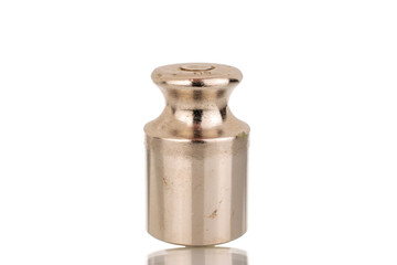 One metal weight for old jewelry scales, macro, isolated on white background.