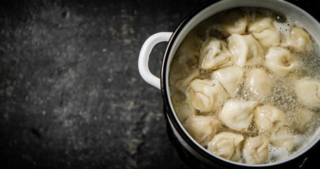 Dumplings are boiled in a saucepan in boiling water. 