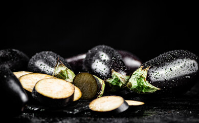 Pieces of ripe eggplant on a stone board. 