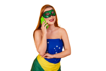 beautiful red-haired Brazilian woman in carnival clothes made with the flag of Brazil, talking on a voice call on her cell phone.
