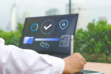 businessman  working on a laptop using FTP (File Transfer Protocol) with a paperless system