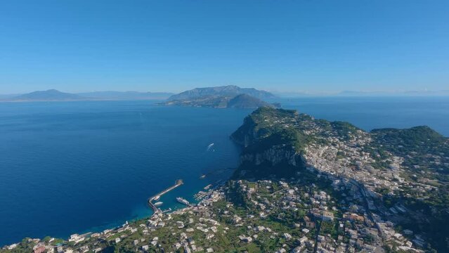 Touristic Town on Capri Island in Bay of Naples, Italy. Sunny Blue Sky. Nature Background. View from top of Mountain. Slow Motion Cinematic Pan