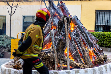 Firefighter watches over the almost extinguished fire