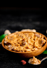 Peanut butter in a plate and spoon. 