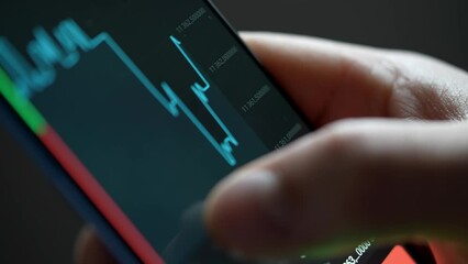 Buying stocks in the investment market in close-up. Checking data in the financial market. Using your phone to analyze a rising stock fund. Displaying a stock market chart on a touch screen monitor. - Powered by Adobe
