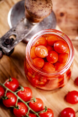 Pickled ripe tomatoes in a glass jar. 